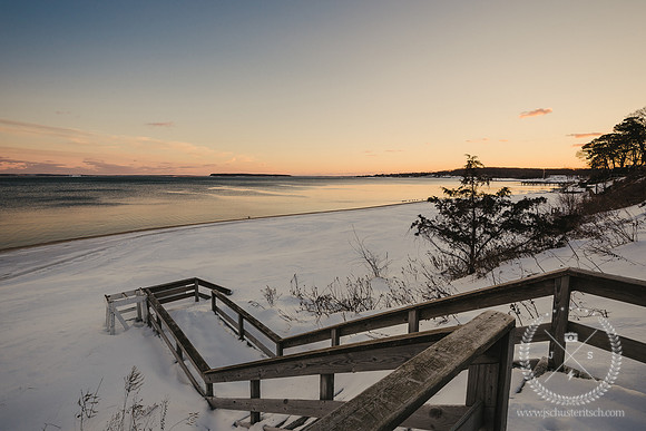 Stairs to a Snowy Beach at Sunset